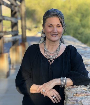Portrait of the Sonoran Sanctuary Candle Studio founder Isabel Baney outdoors in the desert landscape